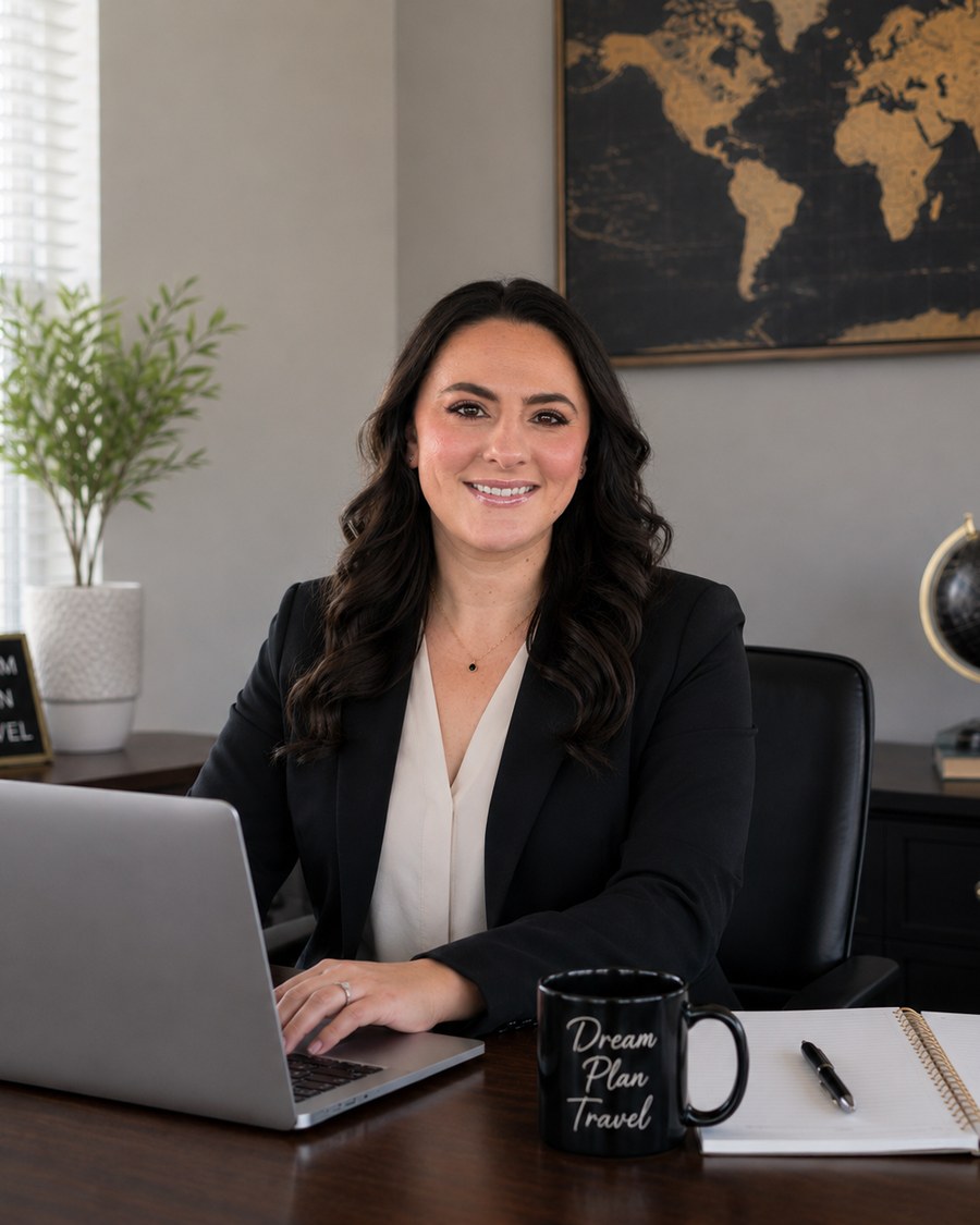 Christina Stewart working at her desk, planning a client's trip